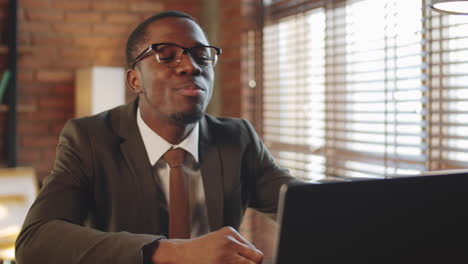 Black-Businessman-Web-Conferencing-on-Laptop